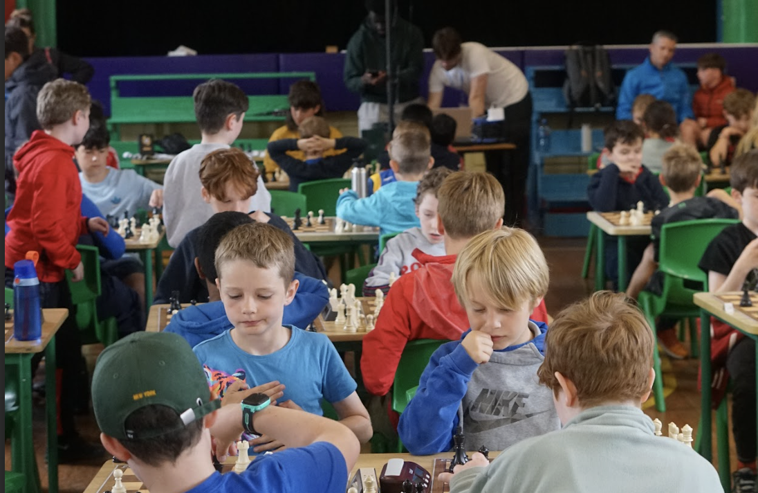 A child smiling at a chess class